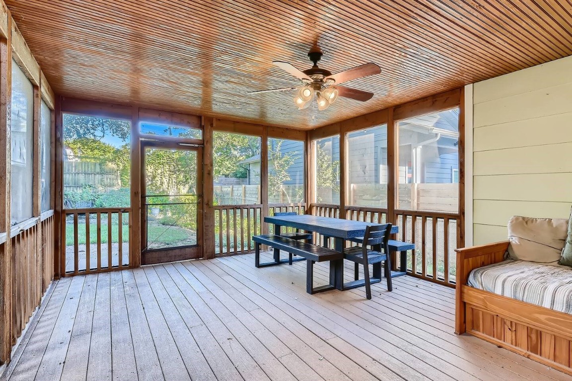 2704 Stacy Lane Austin, TX 78704 - Photo 12 of 15 Sunroom featuring a ceiling fan, a wooden deck, and outdoor dining area