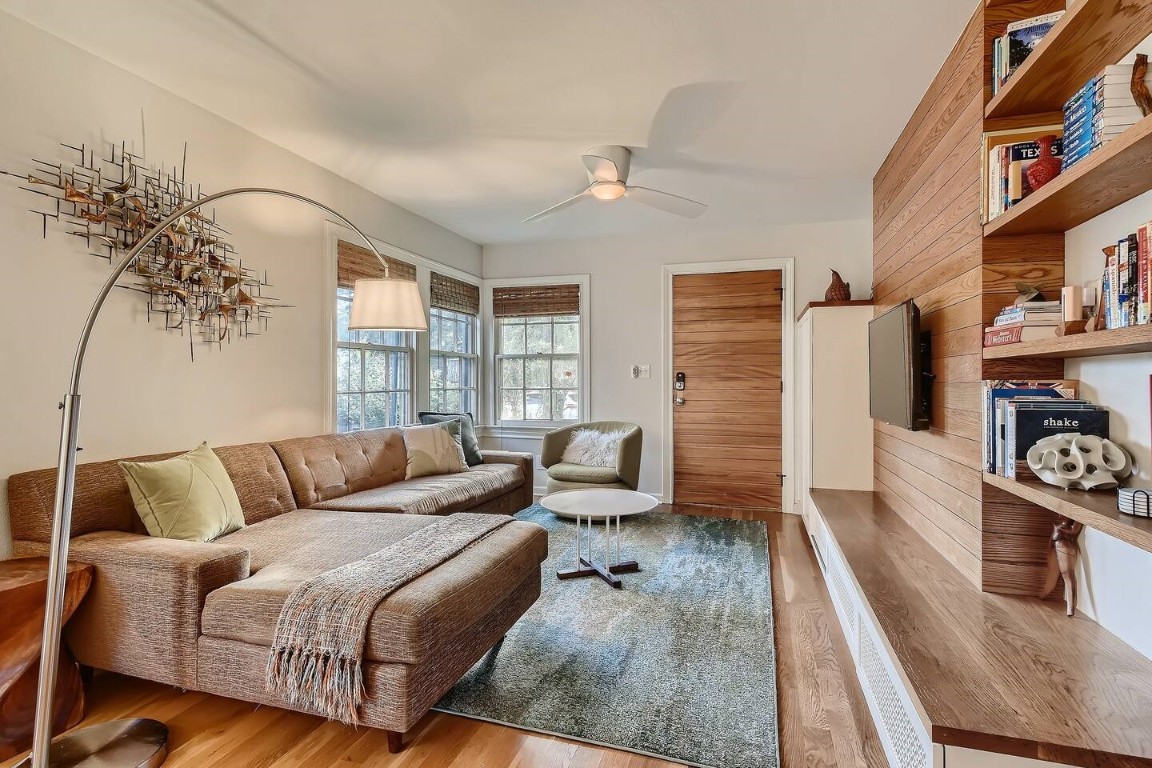 2704 Stacy Lane Austin, TX 78704 - Photo 3 of 15 Living area with a ceiling fan, wood finished floors, and wooden walls