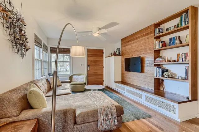a bedroom with furniture and a book shelf