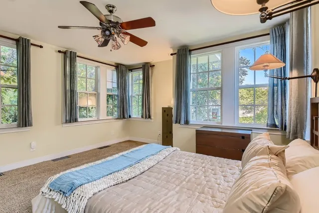 a bedroom with a large bed and a large window