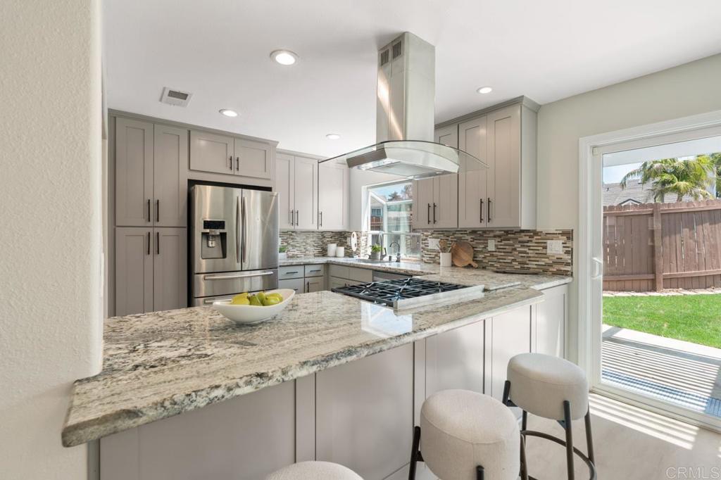 536 Heather Ridge Road San Marcos, CA 92078 - Photo 25 of 66 a kitchen with stainless steel appliances granite countertop a sink and a refrigerator