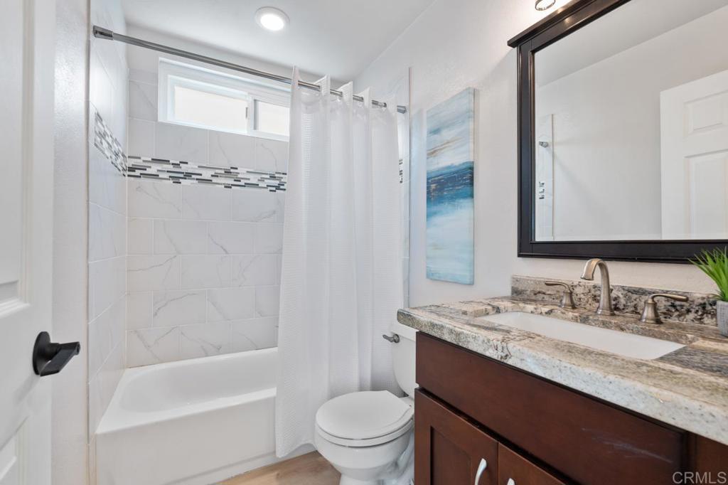 536 Heather Ridge Road San Marcos, CA 92078 - Photo 36 of 66 a bathroom with a granite countertop sink mirror toilet and bathtub