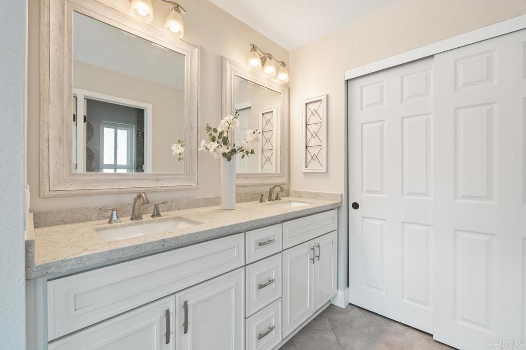 536 Heather Ridge Road San Marcos, CA 92078 - Photo 42 of 66 a bathroom with a double vanity sink and a mirror