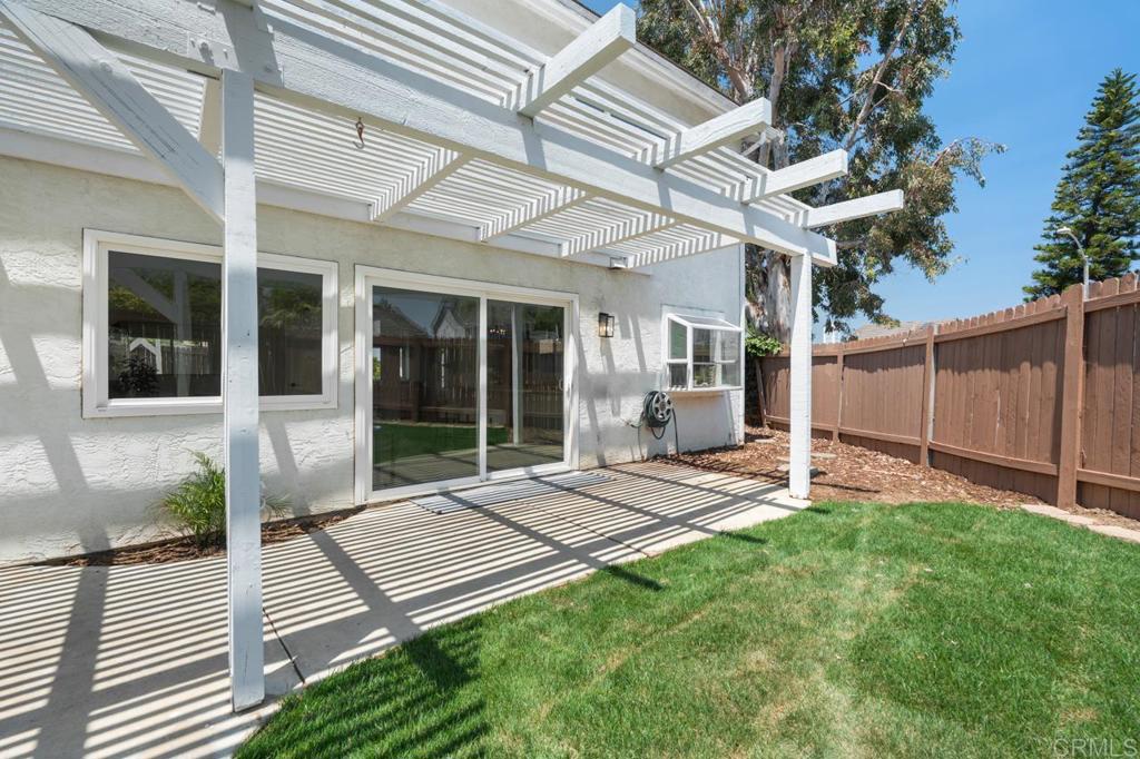 536 Heather Ridge Road San Marcos, CA 92078 - Photo 53 of 66 a view of a backyard with chairs and floor to ceiling window