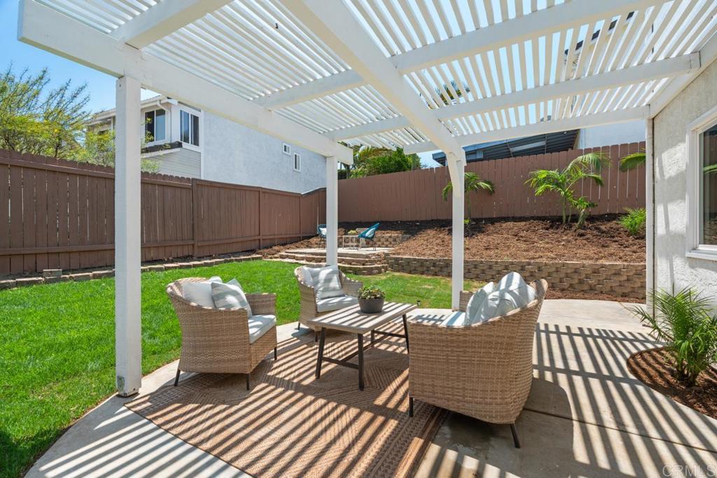 536 Heather Ridge Road San Marcos, CA 92078 - Photo 57 of 66 a view of a patio with table and chairs barbeque with wooden floor and fence