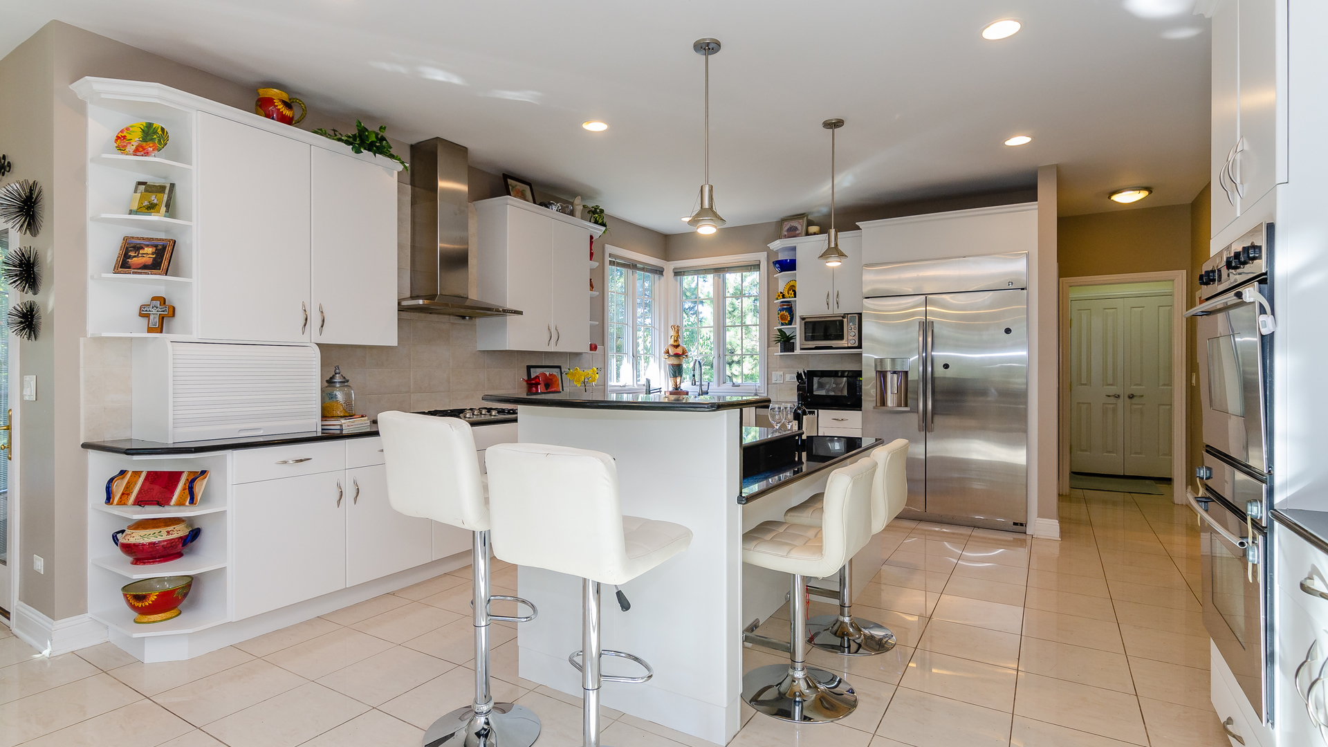 6919 Fieldstone Drive Burr Ridge, IL 60527 - Photo 14 of 58 a kitchen with kitchen island stainless steel appliances a refrigerator and microwave