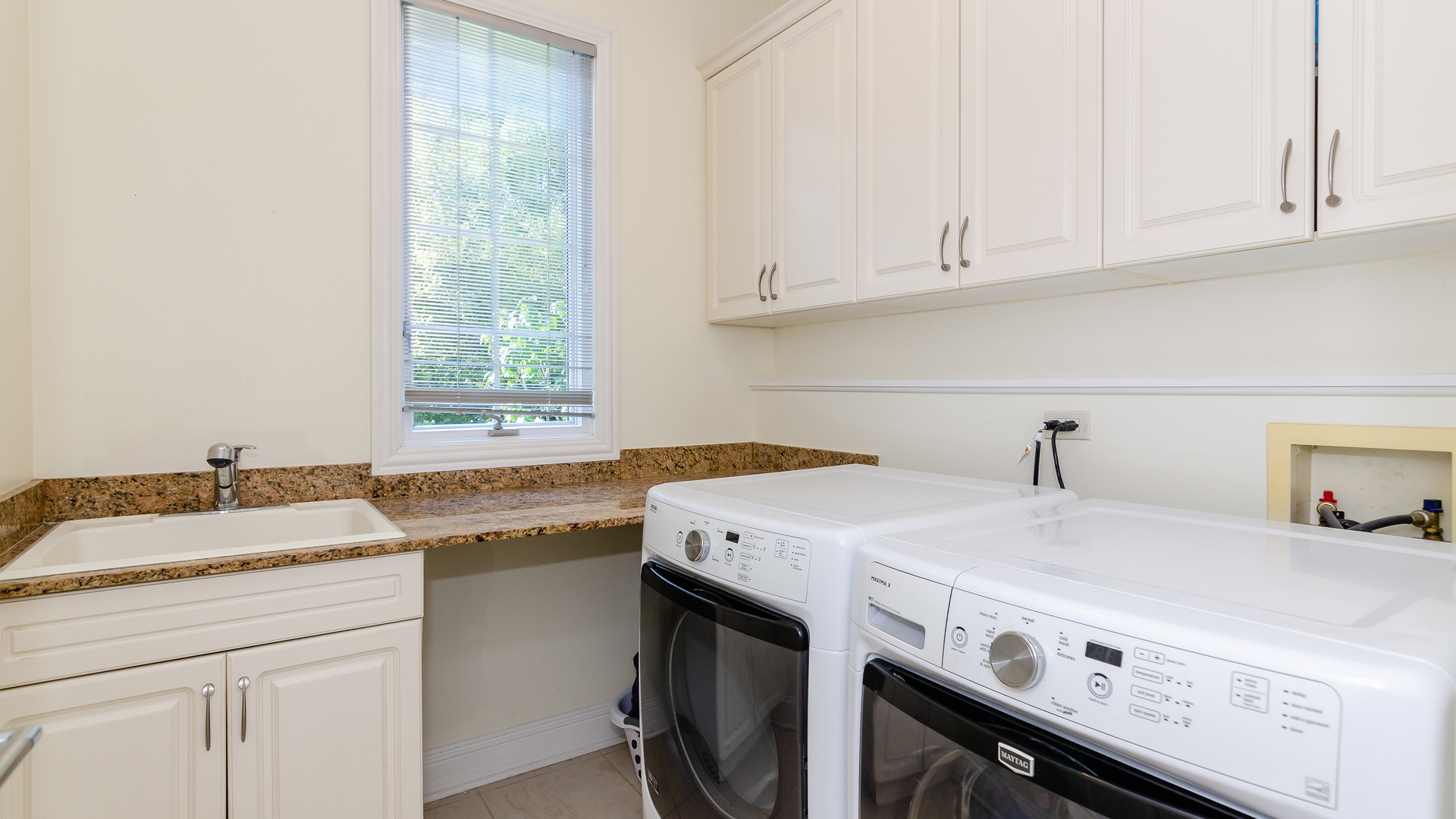 6919 Fieldstone Drive Burr Ridge, IL 60527 - Photo 23 of 58 a utility room with granite countertop a sink a stove and cabinets