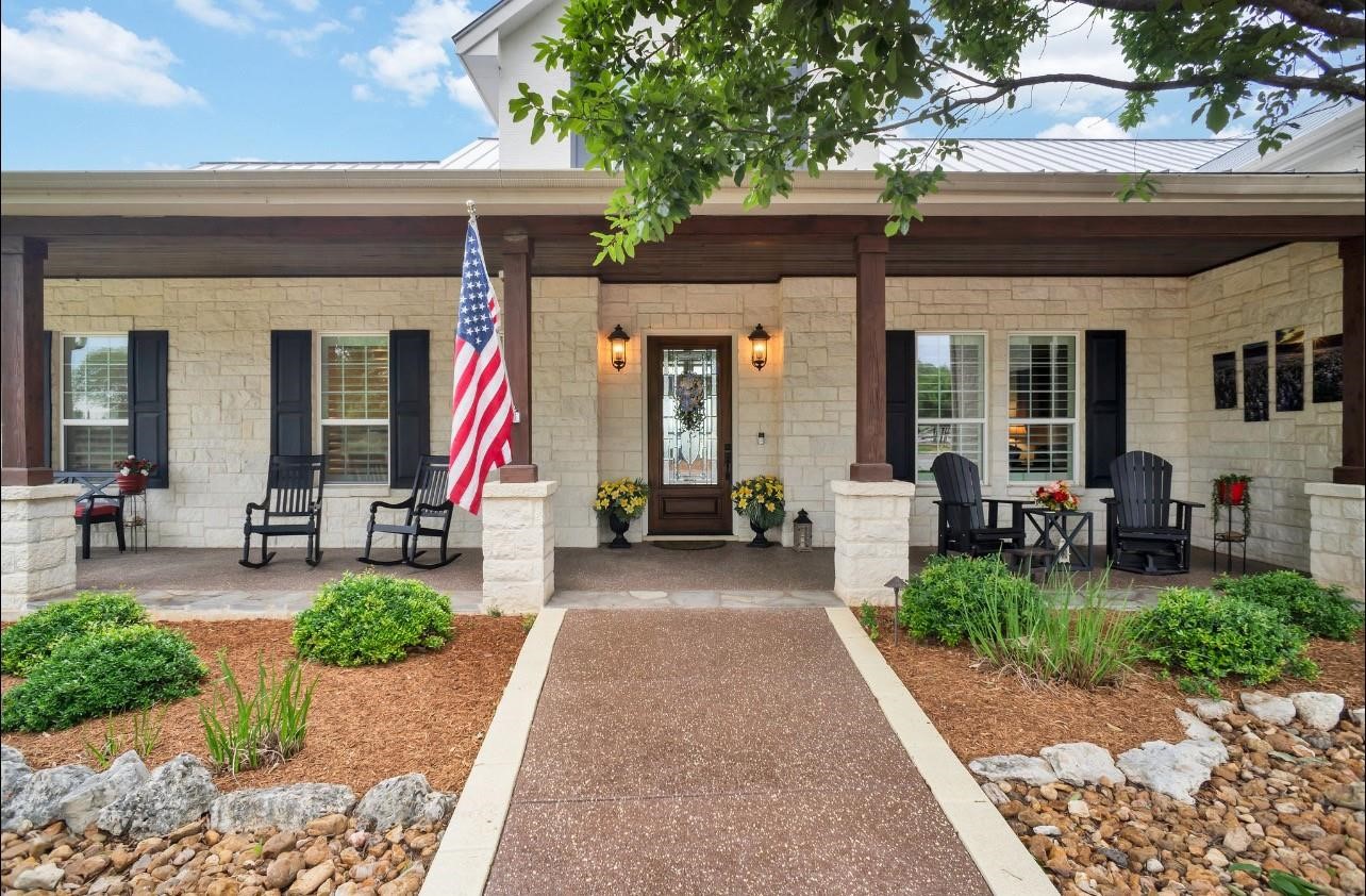 a view of a house with backyard porch and sitting area