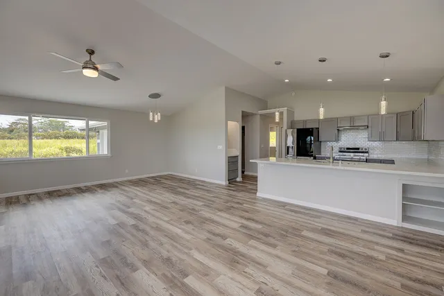 a view of kitchen with stainless steel appliances refrigerator oven and cabinets