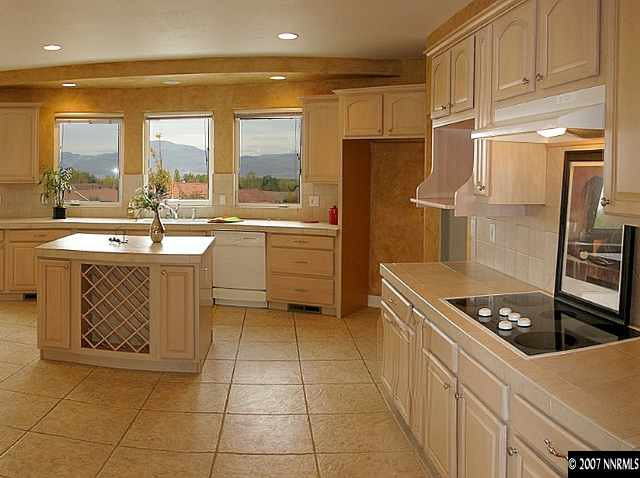 1319 Wolf Run Road Reno, NV 89511 - Photo 4 of 9 a kitchen with stainless steel appliances granite countertop a sink stove and refrigerator