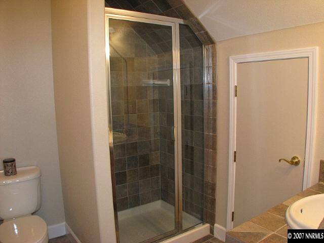 1319 Wolf Run Road Reno, NV 89511 - Photo 8 of 9 a bathroom with a shower a toilet and a sink
