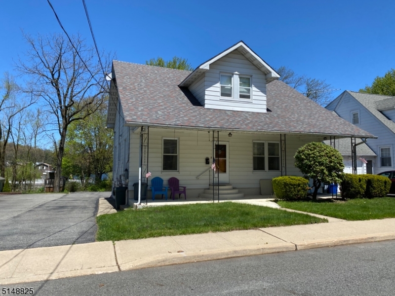 31 Dell Avenue, Unit B Netcong, NJ 07857 - Photo 2 of 6 a front view of a house with a yard and potted plants