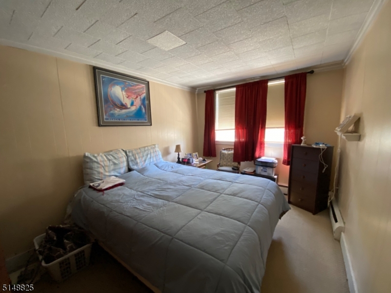 31 Dell Avenue, Unit B Netcong, NJ 07857 - Photo 5 of 6 a bedroom with a bed and a dresser next to a window