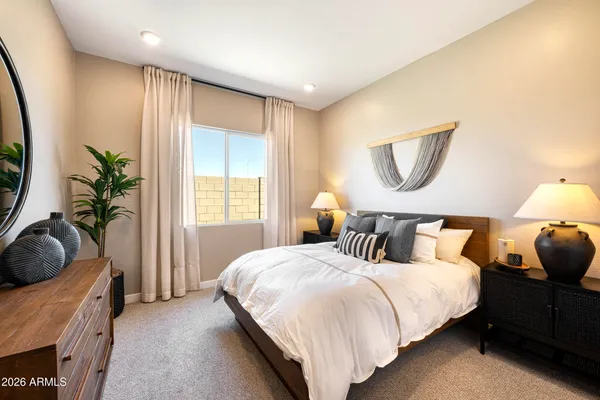 a bedroom with a bed and a potted plant