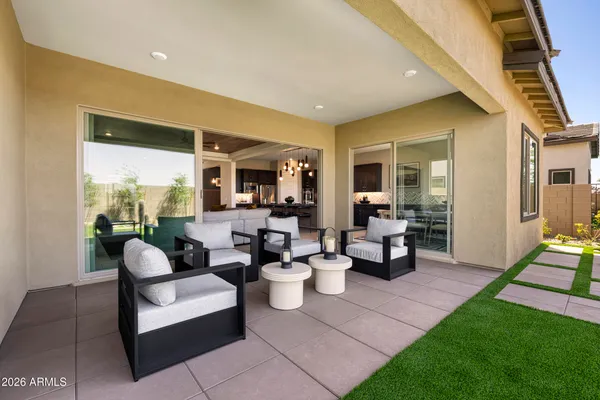 a living room with fireplace furniture and a rug