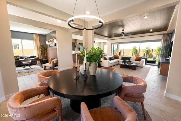 a view of a dining room with furniture and chandelier