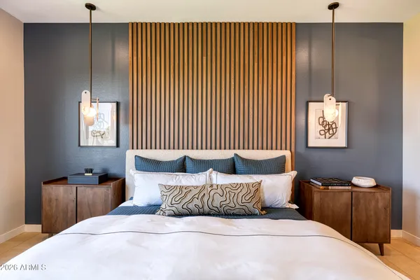 a bedroom with a bed and a chandelier