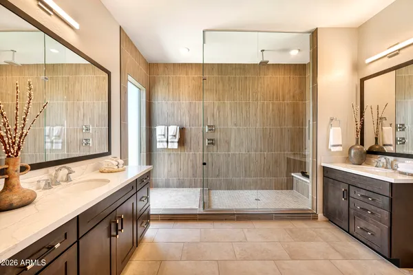 a bathroom with a granite countertop sink a mirror and a bathtub