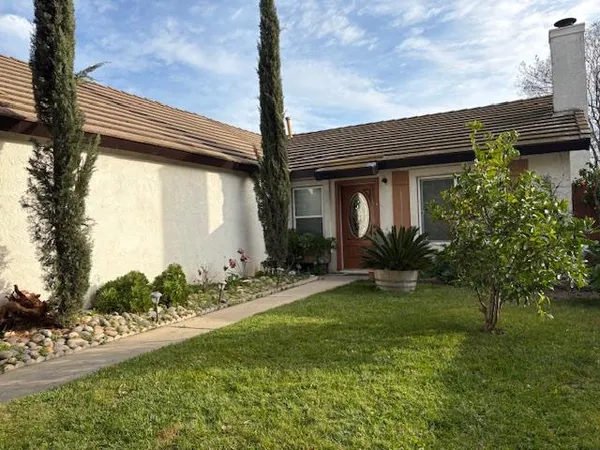 a view of a house with a yard and plants