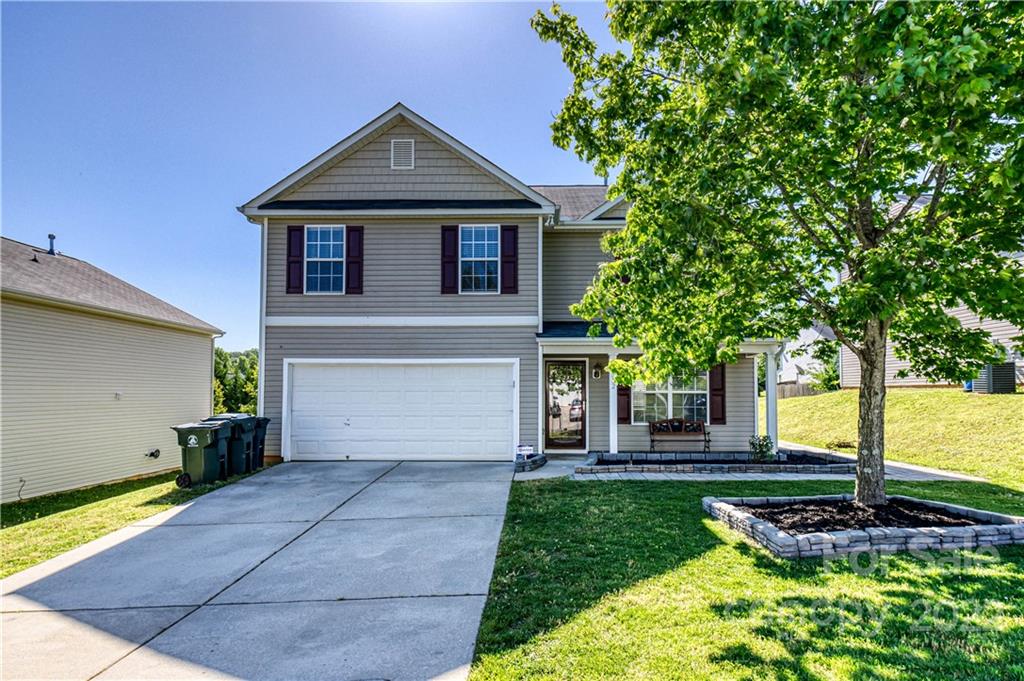 722 Overlook Road Lowell, NC 28098 - Photo 1 of 22 a front view of a house with a garden