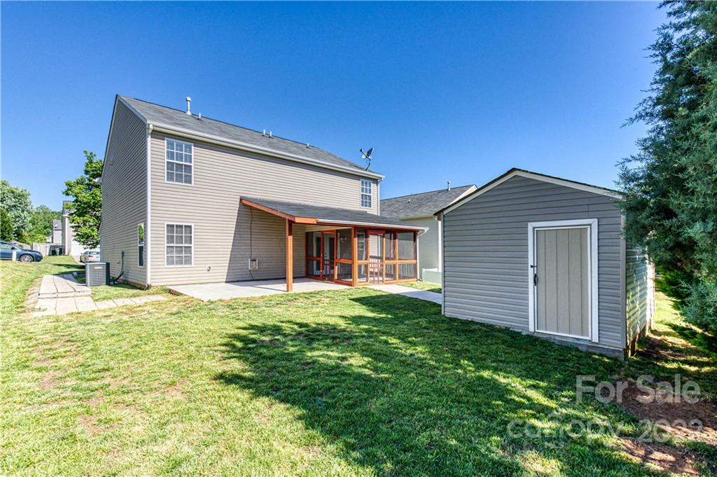 722 Overlook Road Lowell, NC 28098 - Photo 19 of 22 a front view of house with yard and trees in the background