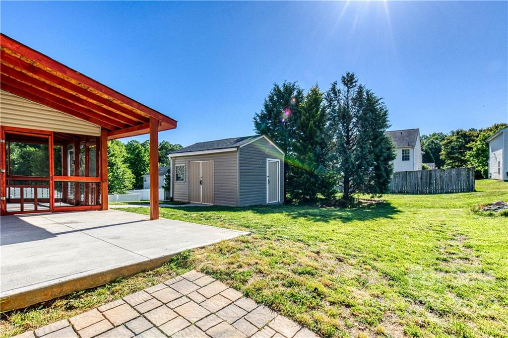 722 Overlook Road Lowell, NC 28098 - Photo 22 of 22 a backyard of a house with yard and outdoor seating