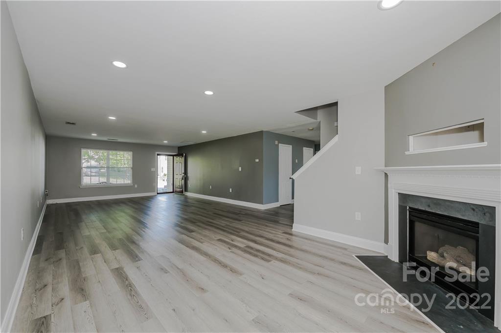722 Overlook Road Lowell, NC 28098 - Photo 4 of 22 a view of empty room with wooden floor and fireplace