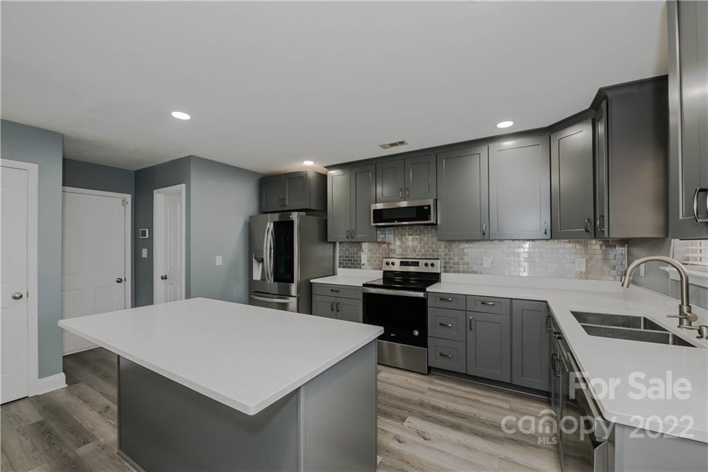 722 Overlook Road Lowell, NC 28098 - Photo 8 of 22 a kitchen with stainless steel appliances a sink stove and refrigerator