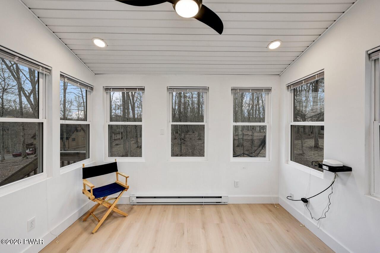 258 Lakeview Road Lackawaxen, PA 18435 - Photo 28 of 119 a view of an empty room with wooden floor and windows