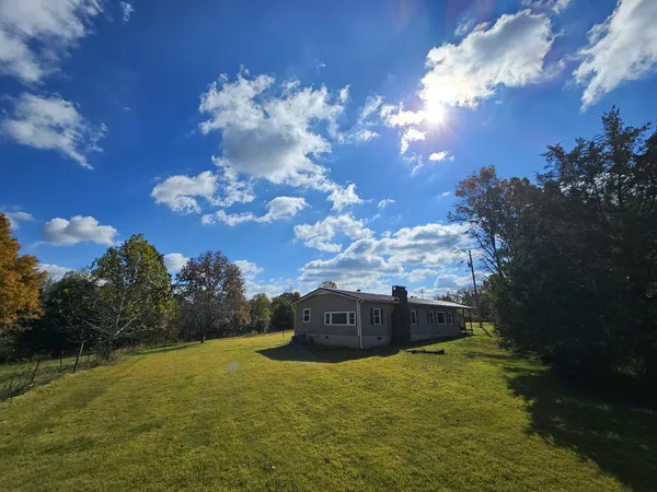 a view of a brick house with a big yard