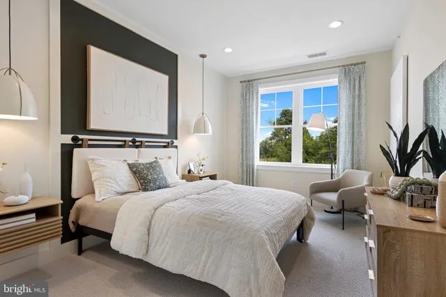 a bedroom with bed couch and window