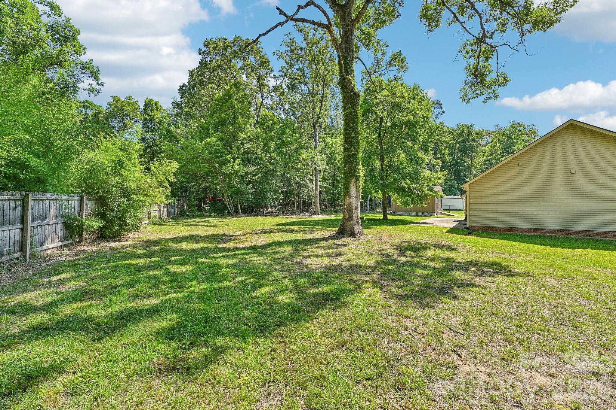 624 Hunley Street Monroe, NC 28112 - Photo 29 of 36 a view of outdoor space with deck and trees