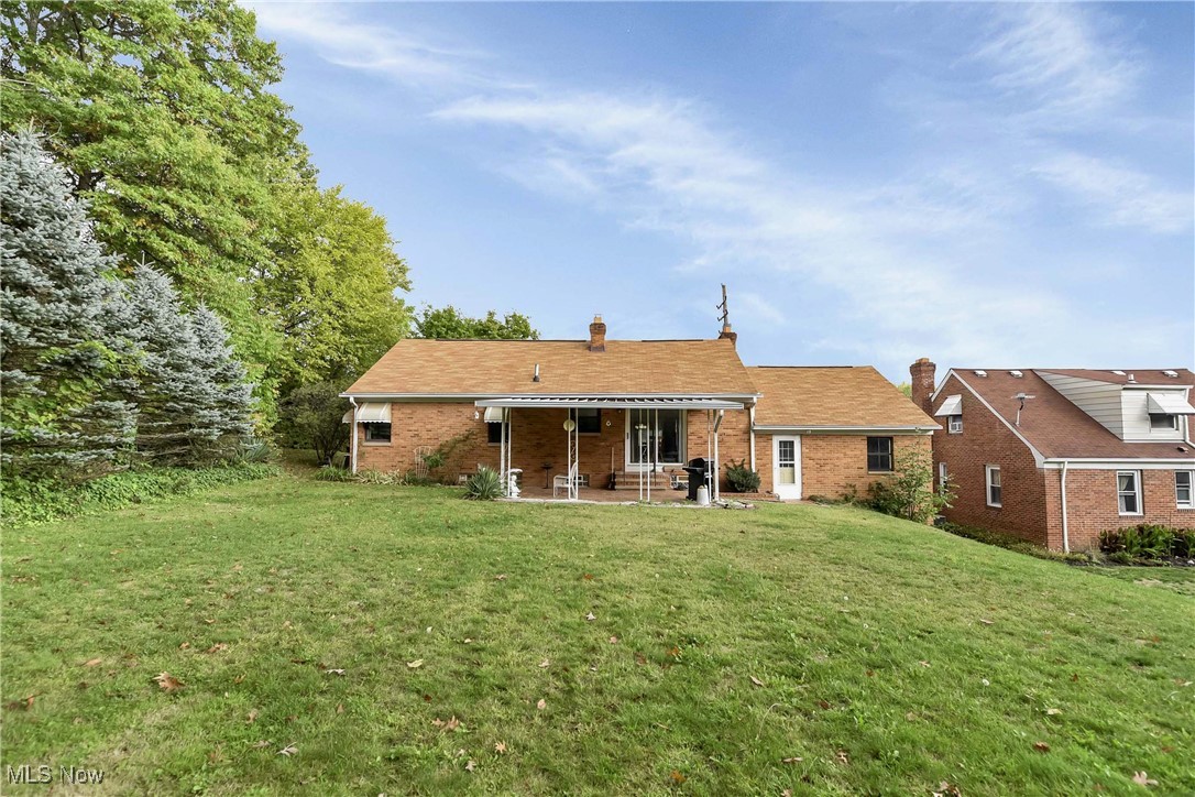 4908 East Pleasant Valley Road Independence, OH 44131 - Photo 28 of 31 Back of house with a patio and a lawn