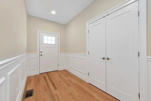 a view of empty room with wooden floor