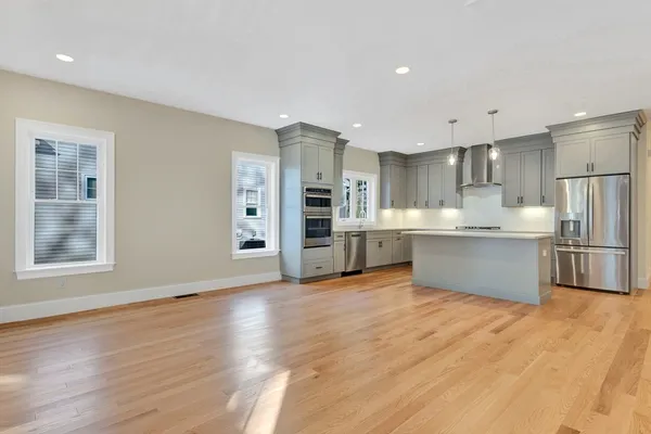 a view of kitchen with wooden floor and electronic appliances