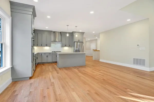 a view of kitchen and hall with wooden floor