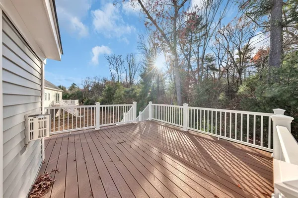 a view of balcony with wooden floor and fence