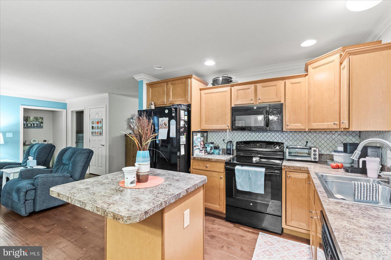 555 Countryside Road Seven Valleys, PA 17360 - Photo 17 of 56 a kitchen with stainless steel appliances granite countertop a sink stove and refrigerator