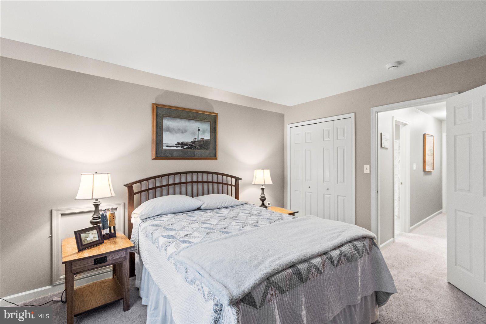 555 Countryside Road Seven Valleys, PA 17360 - Photo 28 of 56 a bedroom with a bed a painting and a lamp