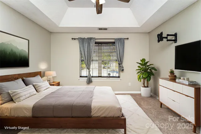 a bedroom with a balcony a bed and a flat screen tv