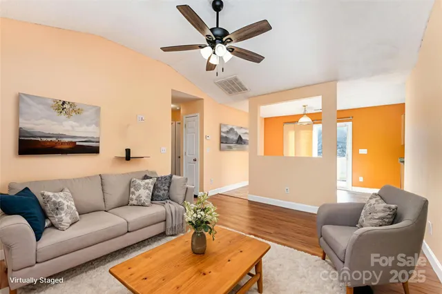 a living room with furniture and a large window