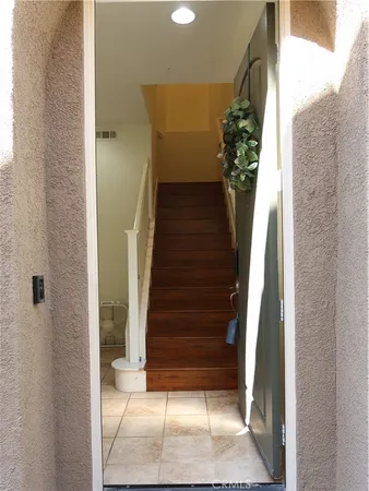 a view of a livingroom with wooden floor and a ceiling fan