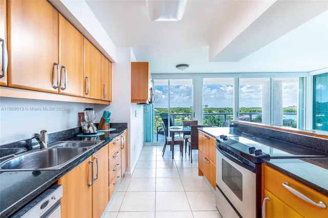 a kitchen with granite countertop a sink and stove