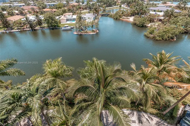 an aerial view of a houses with ocean view