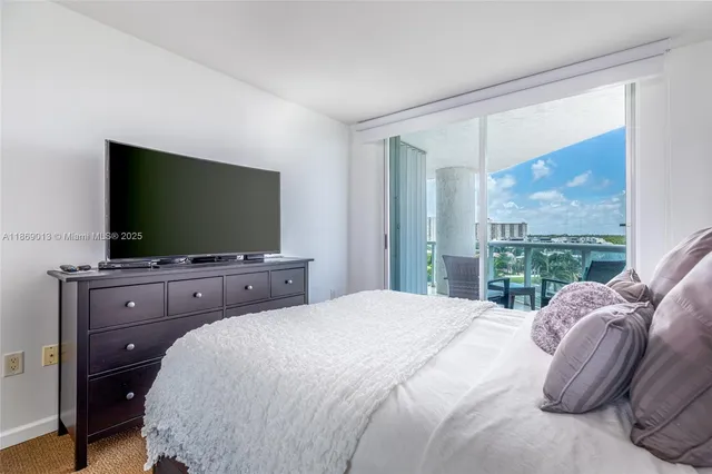a bedroom with a large bed and a flat screen tv