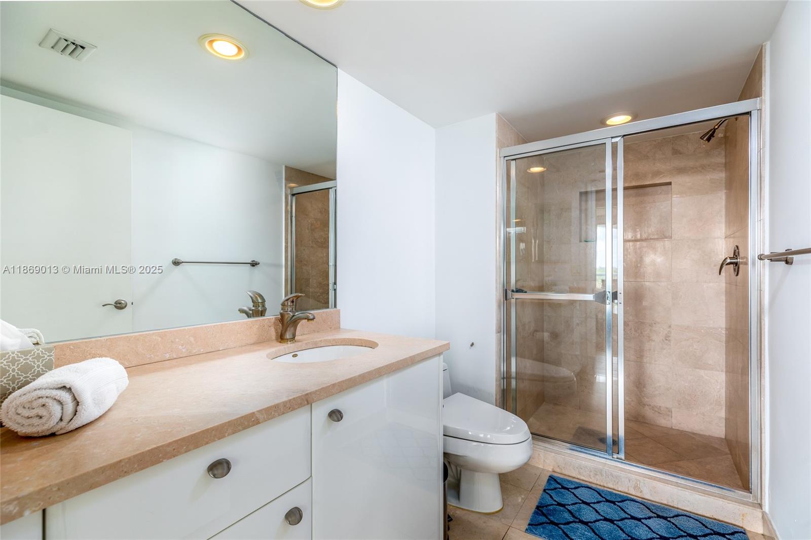 16500 Collins Avenue, Unit 655 Sunny Isles Beach, FL 33160 - Photo 33 of 48 a bathroom with a sink a toilet and shower