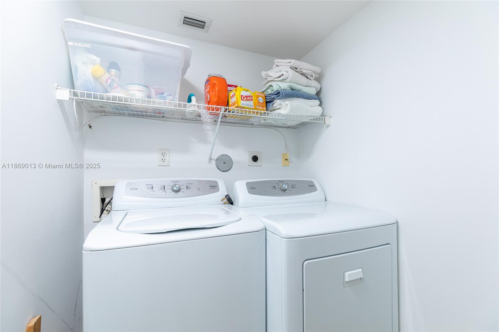 16500 Collins Avenue, Unit 655 Sunny Isles Beach, FL 33160 - Photo 35 of 48 a utility room with dryer and washer