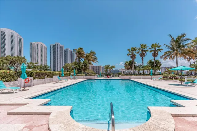 a swimming pool with outdoor seating and yard