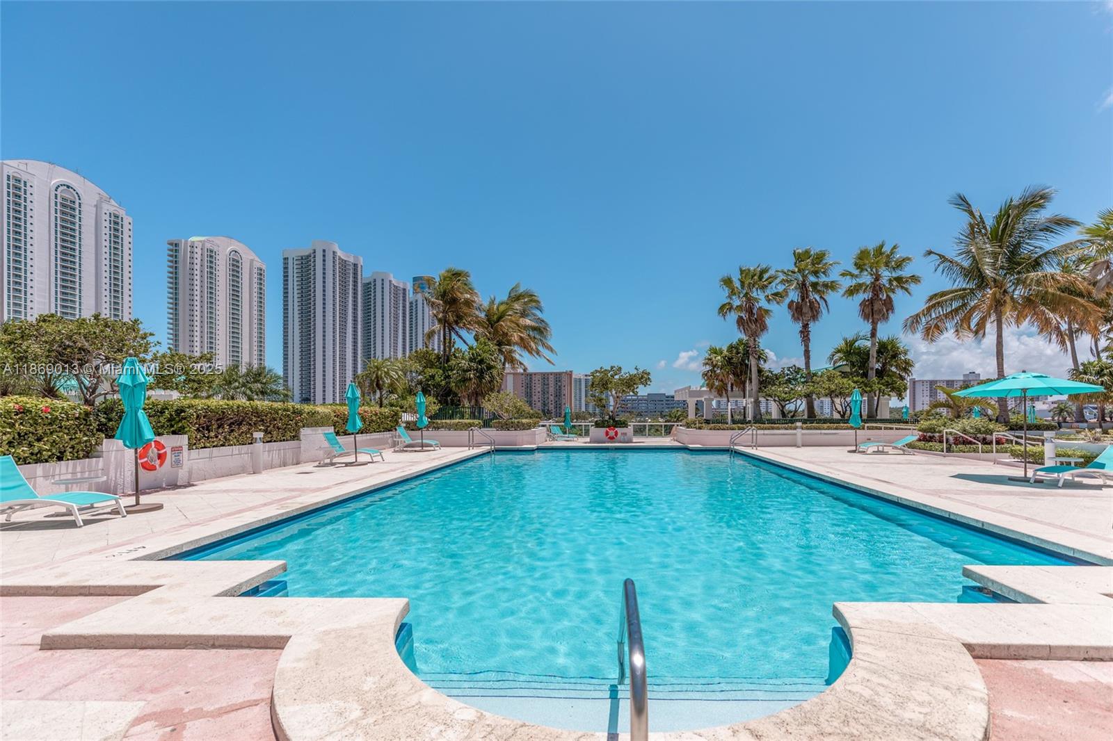 16500 Collins Avenue, Unit 655 Sunny Isles Beach, FL 33160 - Photo 36 of 48 a swimming pool with outdoor seating and yard
