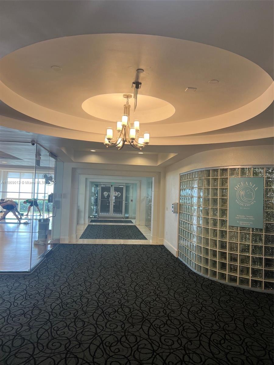 16500 Collins Avenue, Unit 655 Sunny Isles Beach, FL 33160 - Photo 41 of 48 a living room with furniture and a chandelier